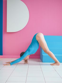 Female practicing yoga in a vibrant indoor setting, enhancing flexibility.