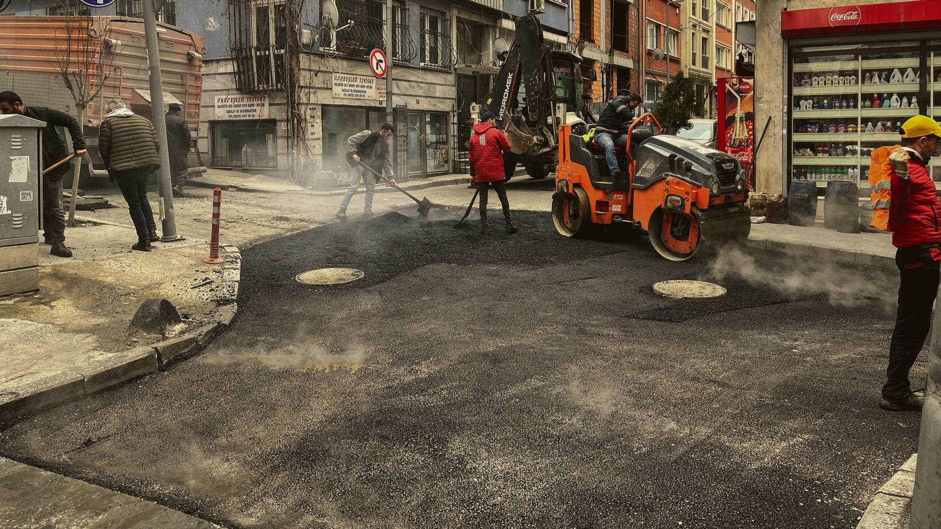 Men working on asphalt road construction in İstanbul street.