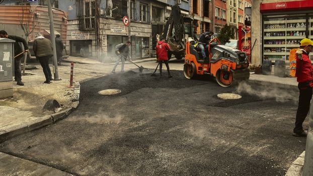 Men working on asphalt road construction in İstanbul street.