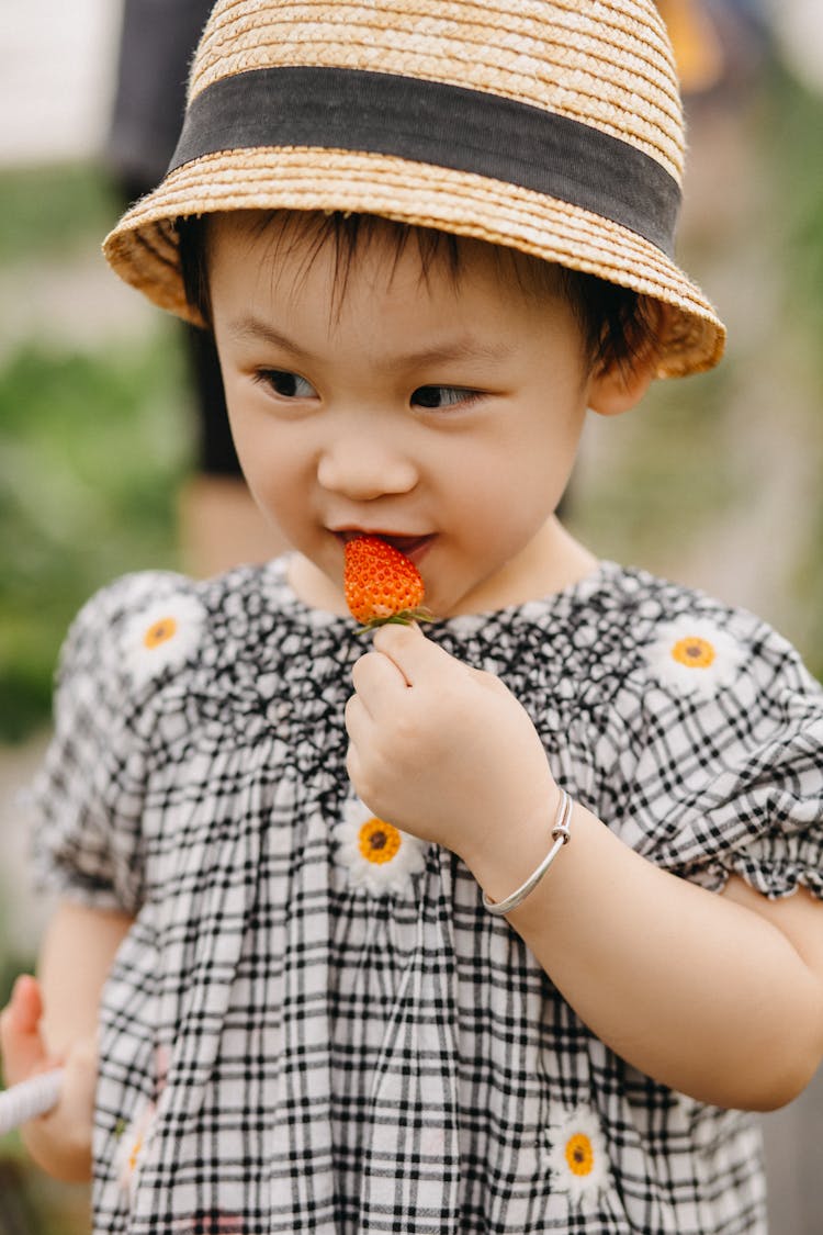 Little Girl Eating Strawberry