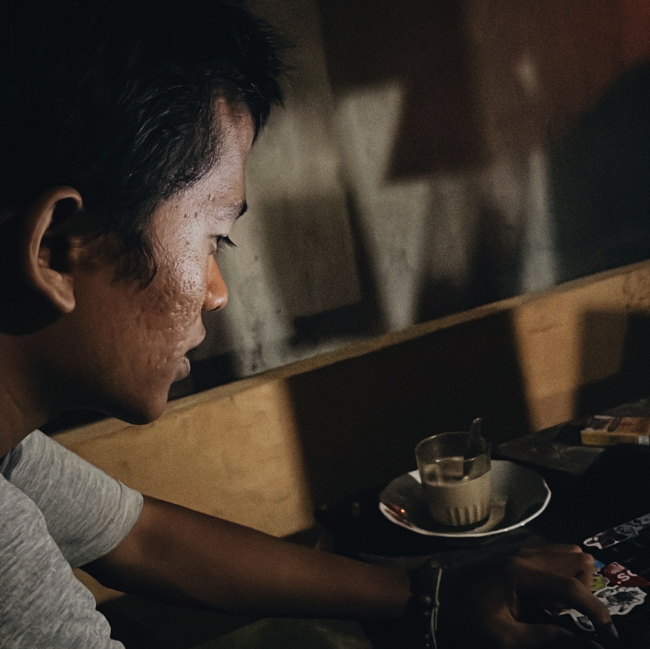 Asian man enjoying a quiet moment in a cafe.
