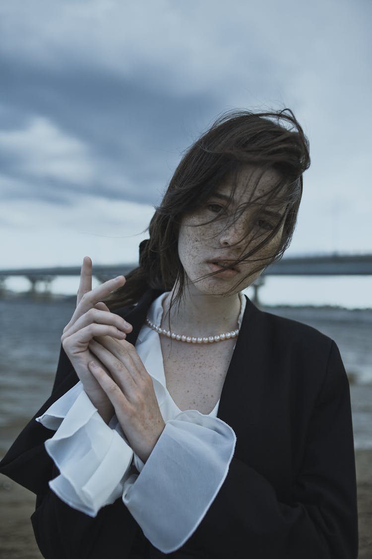 Portrait Of Girl With Freckles And Hands Clasped