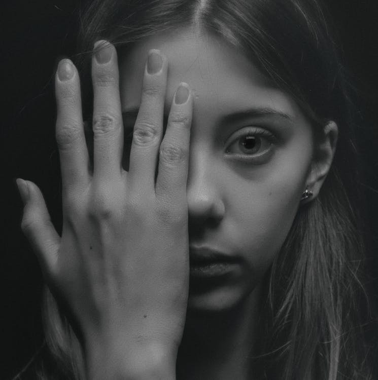 Free Grayscale Photo of Woman Covering Her Face by Her Hand Stock Photo
