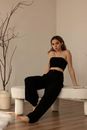Woman in Black Sweatpants Sitting on Fuzzy Coffee Table
