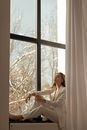 Woman in White Business Outfit Sitting on Window Sill
