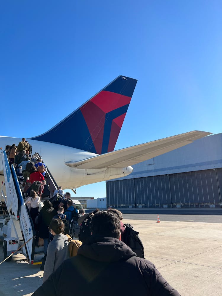 People Boarding An Airplane