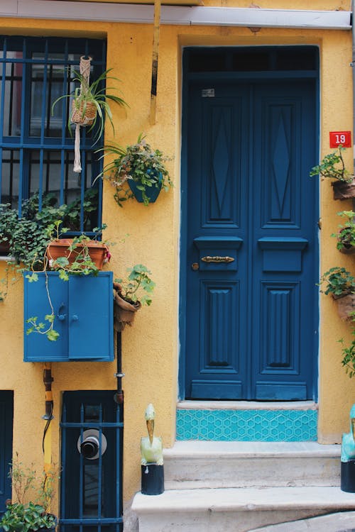Blue Wooden Door on Yellow Wall