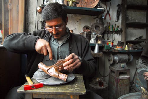 A Man Carving Wood