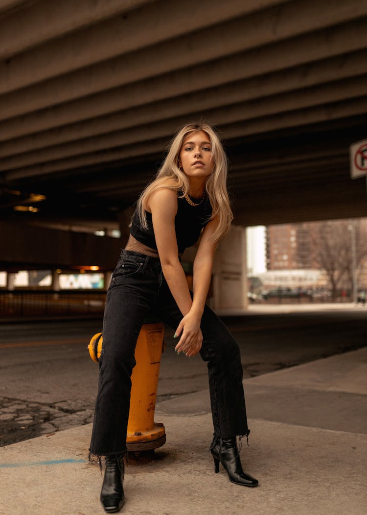 Beautiful Woman Sitting On A Hydrant 