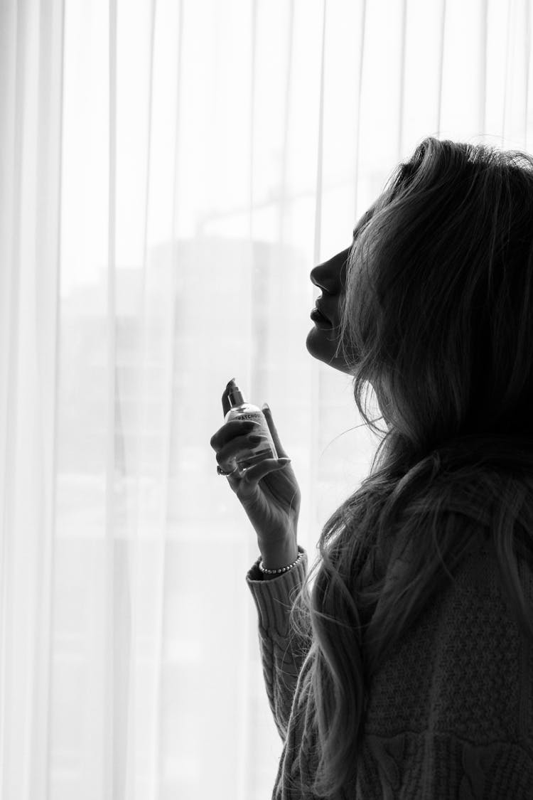  Woman Spraying Perfume On Her Neck