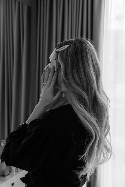 Woman in Long Sleeve Shirt Wearing Facial Mask