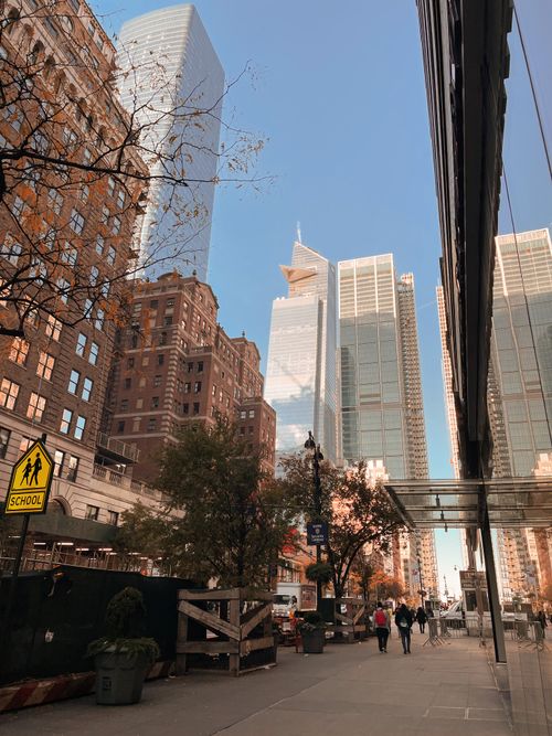 Free Capture of skyscrapers and pedestrians in a bustling New York City street scene. Stock Photo