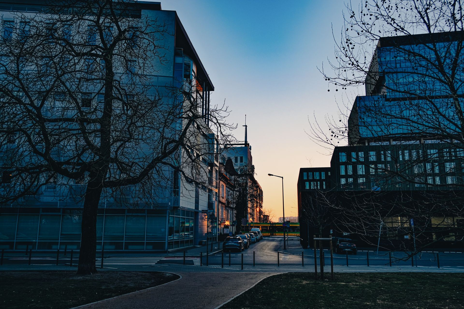 Captivating urban street scene in Poznań, Poland during sunset showcasing modern architecture.