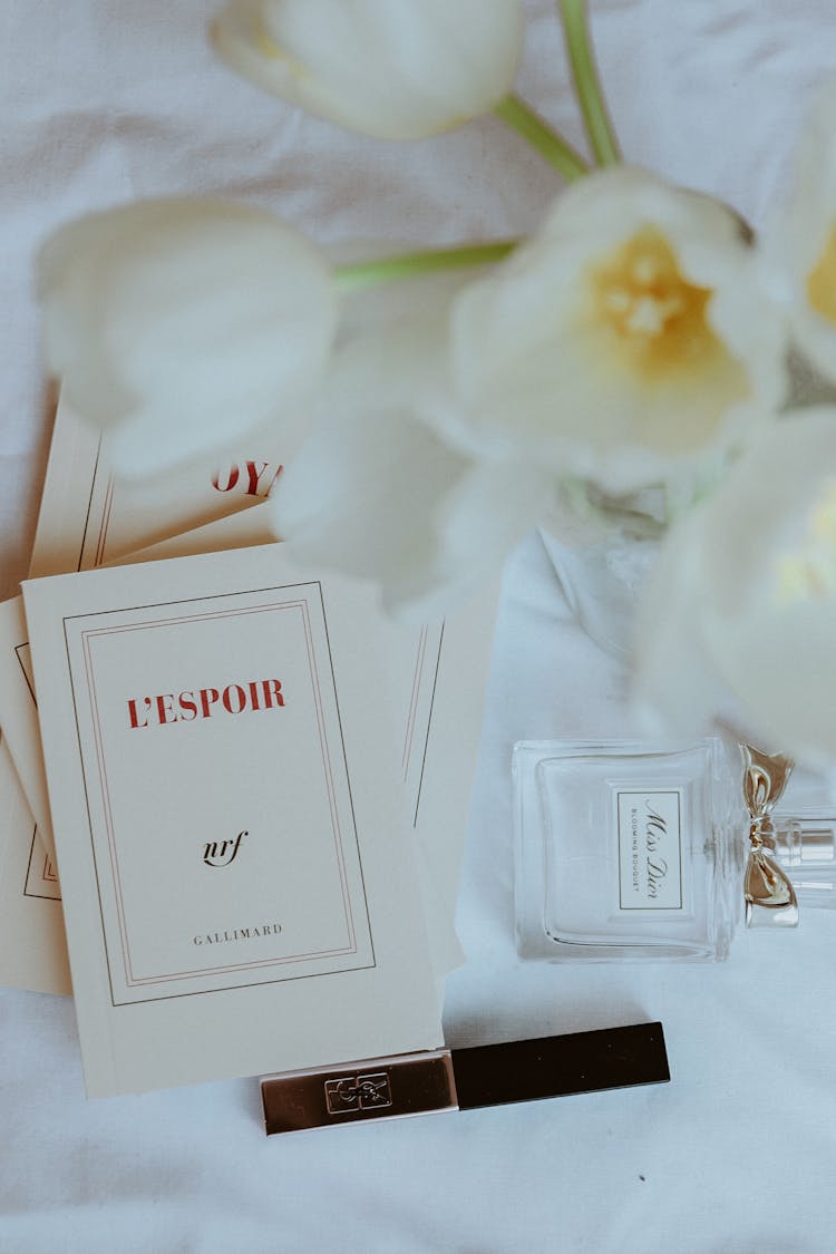 White Flowers And Cards Near Perfume