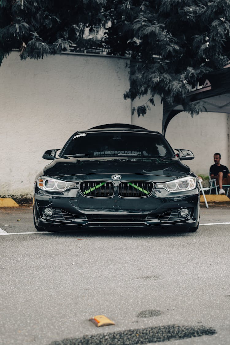 Black Car Parked On Gray Concrete Pavement