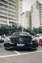 Black Mercedes Benz Coupe on Road Near High Rise Building