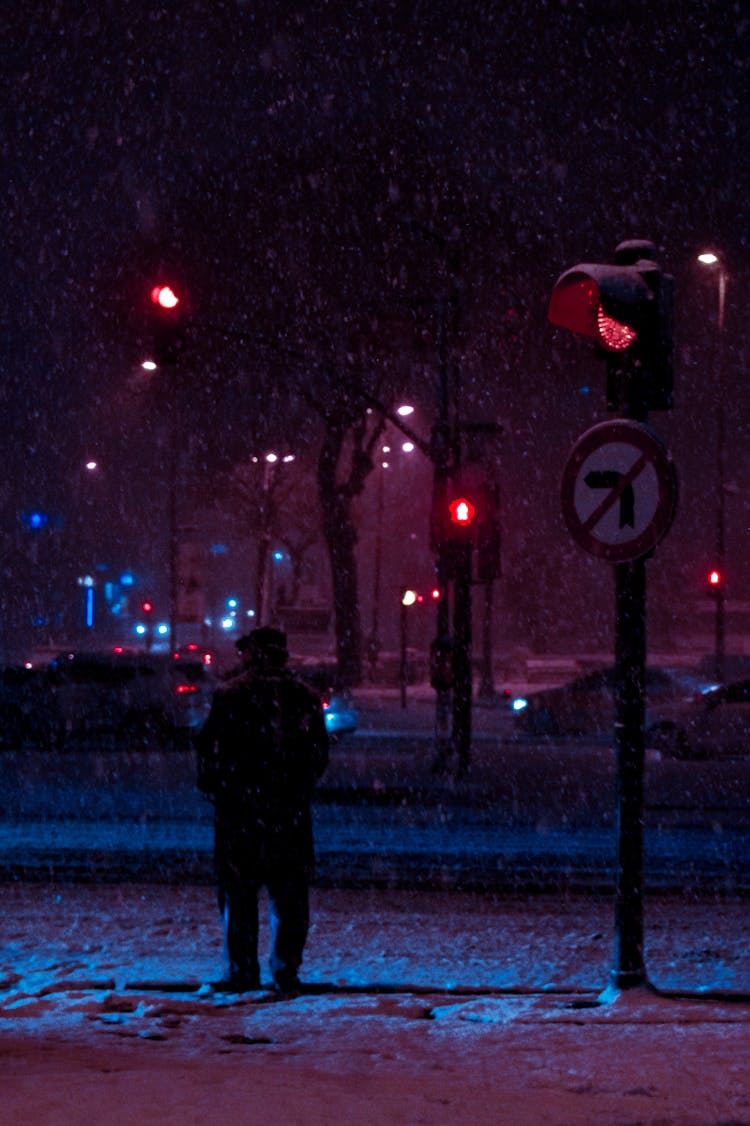 Person In Coat Standing Near Stop Lights