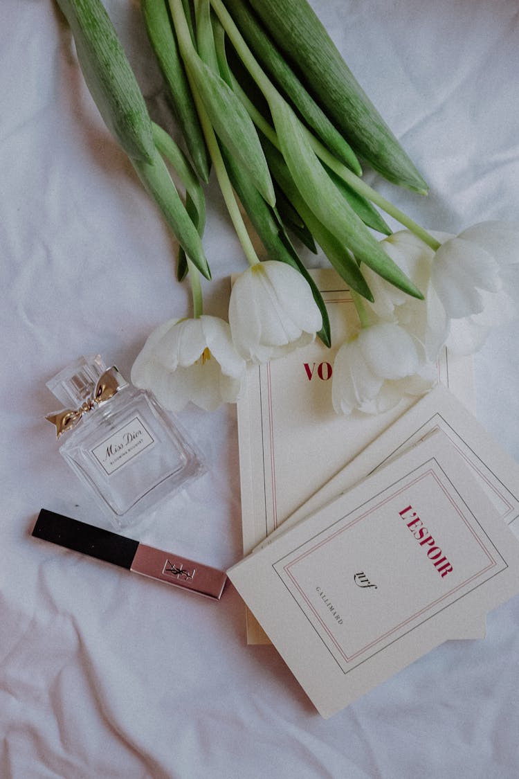 White Tulip Bouquet Beside Perfume Bottle