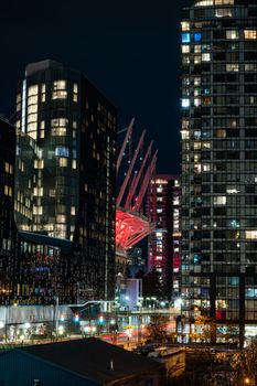Vibrant Vancouver cityscape with illuminated BC Place and modern skyscrapers at night.