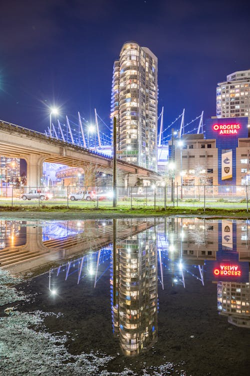 Brown Concrete Building Near Body of Water during Night Time