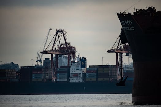 Cranes loading cargo containers onto ships at Vancouver's bustling port.
