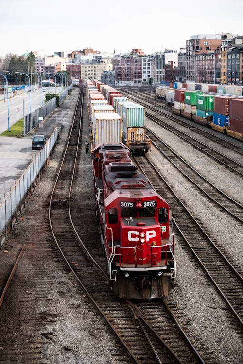 Red and White Train on Rail Tracks