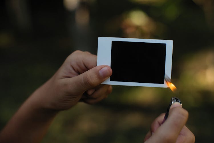 Person Burning A Blank Polaroid Film