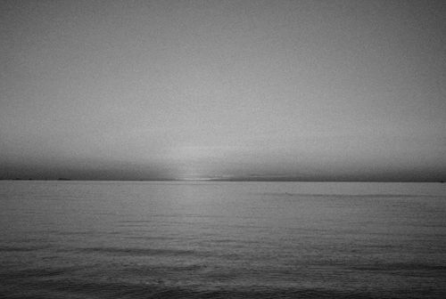 Free Tranquil black and white ocean horizon at dawn, capturing the serene beauty of nature. Stock Photo