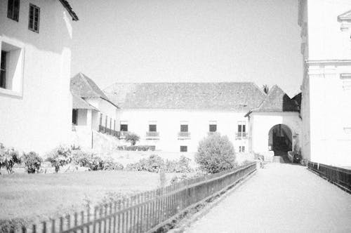 Grayscale Photo of House Near Road