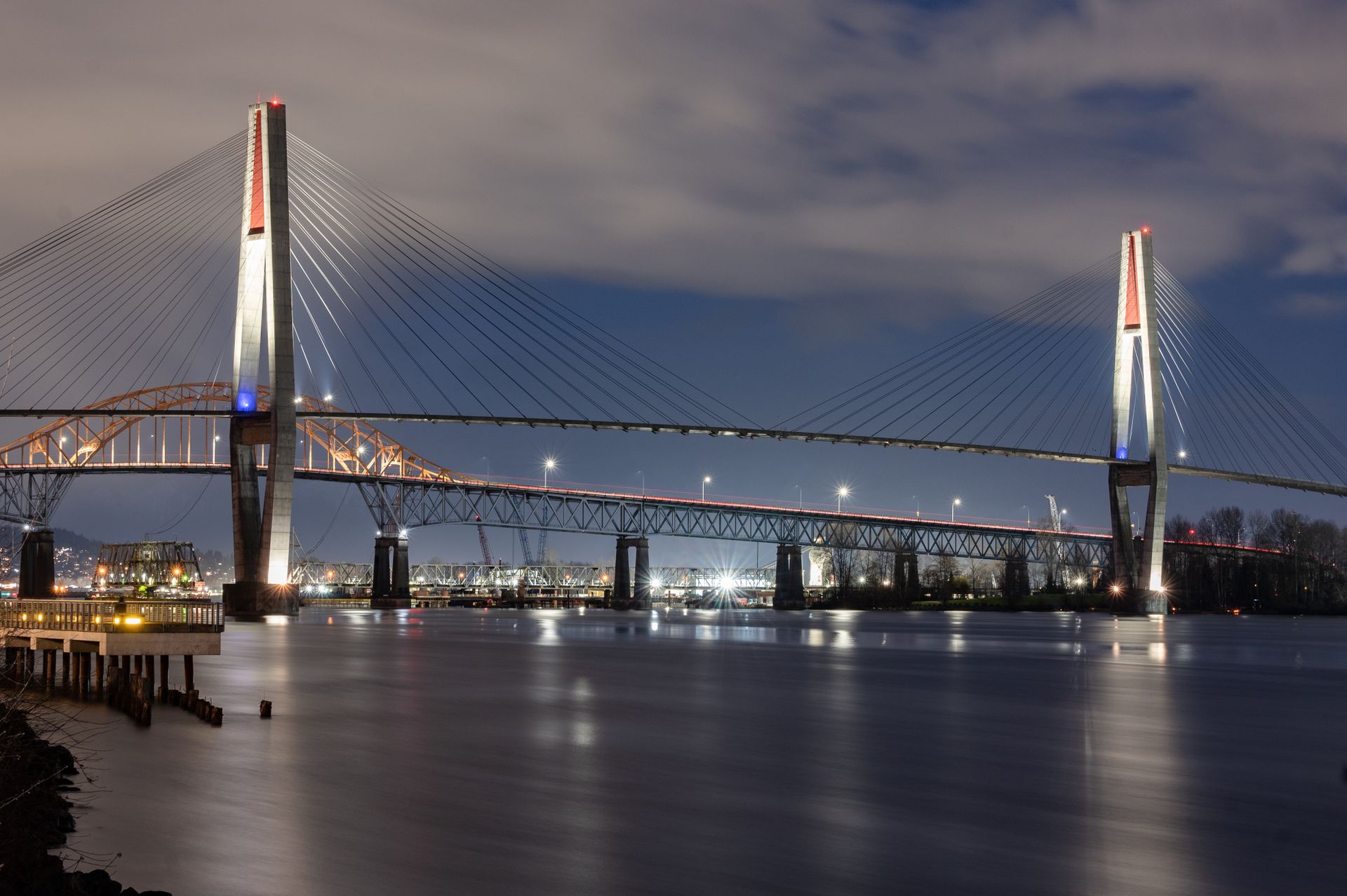 Stunning night view of the illuminated Pattullo Bridge spanning the Fraser River in Surrey, BC, Canada.