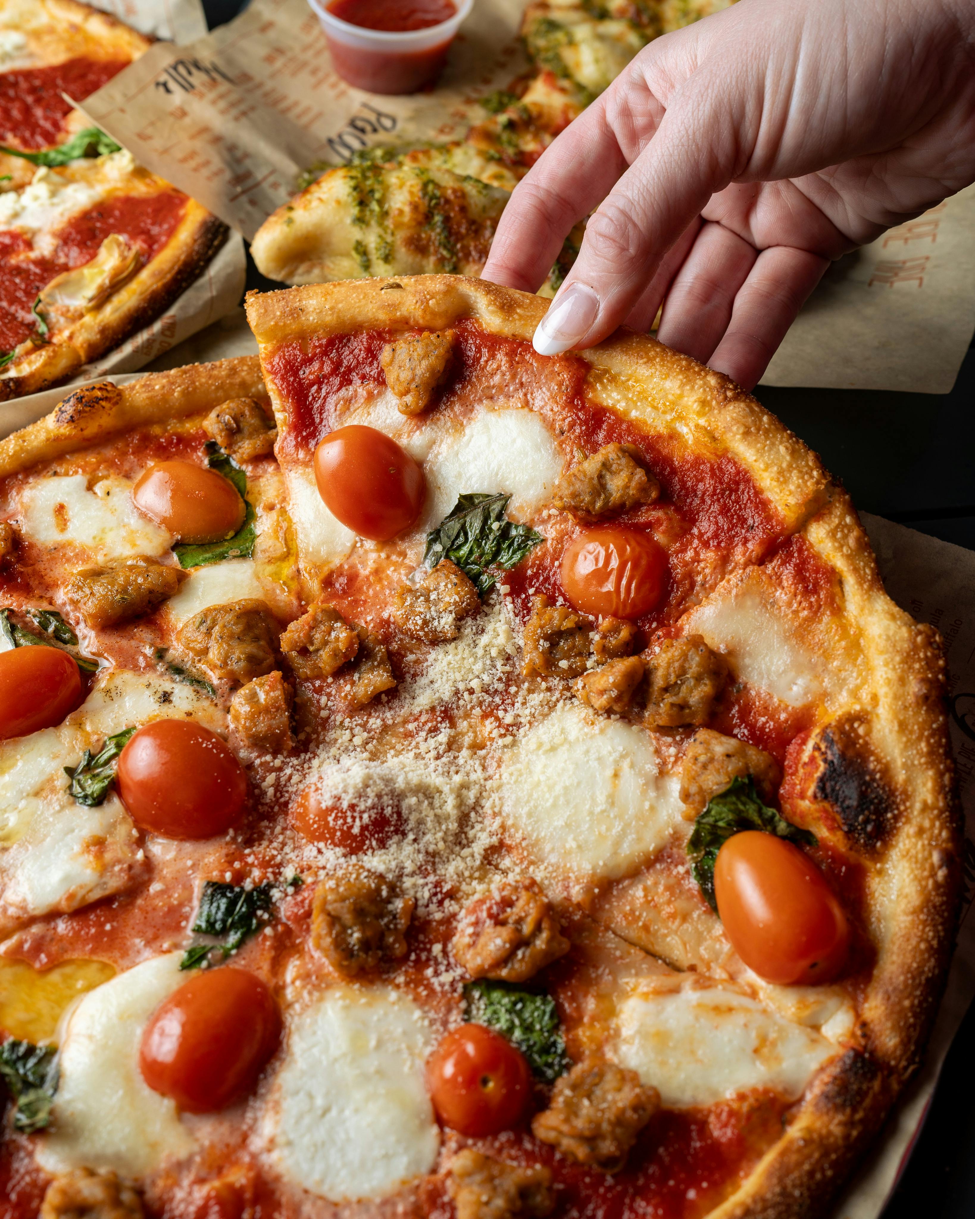 pizza with tomato and green leaves