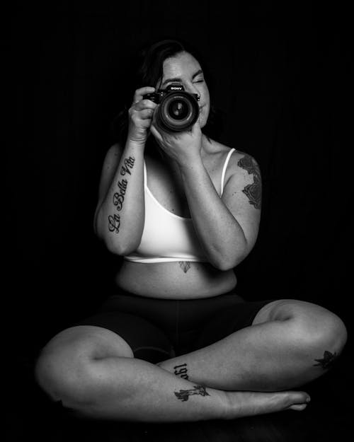 Free Woman in White Crop Top Holding Camera Stock Photo