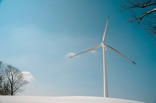 White Wind Turbine Under Blue Sky