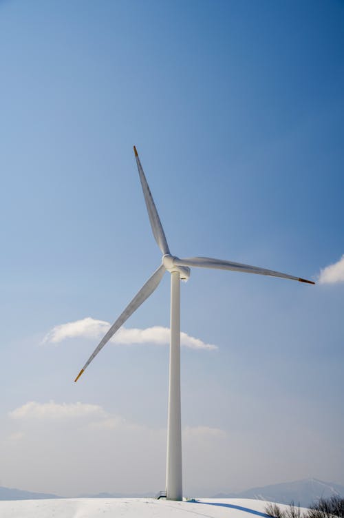 White Wind Turbine Under Blue Sky