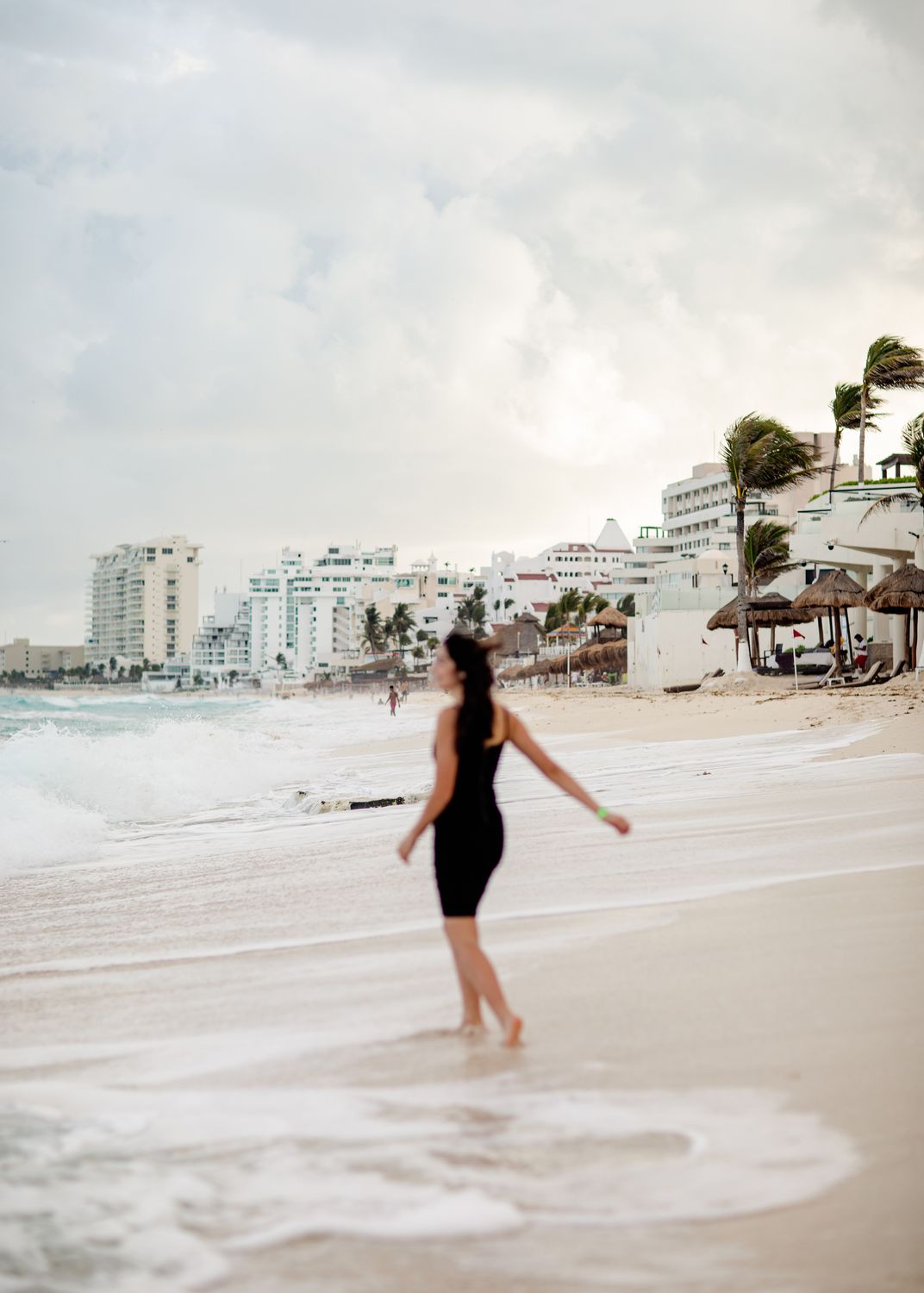 A Woman in Black Dress Walking on Beach · Free Stock Photo