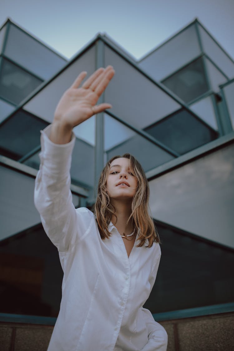 Blond Woman In White Shirt Showing Stop Sign With Hand 