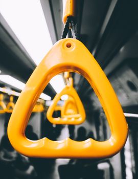 A focused view of yellow handrails inside a public transportation vehicle, creating a modern commuting ambiance.