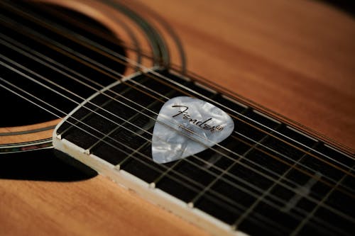Free Acoustic Guitar with White Guitar Pick Stock Photo
