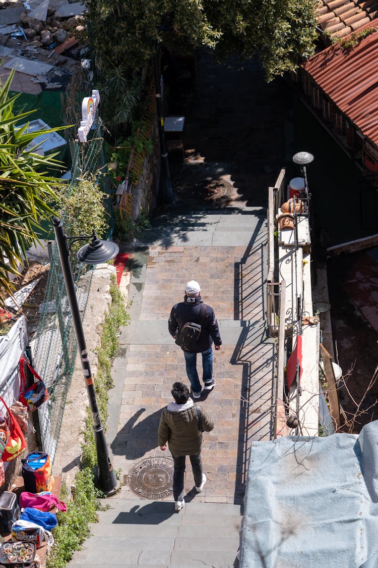 High Angle View Of Pedestrians Walking Down The Sidewalk 