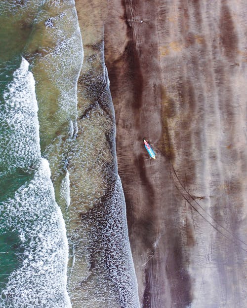 Aerial Shot of Boat on the Seashore 
