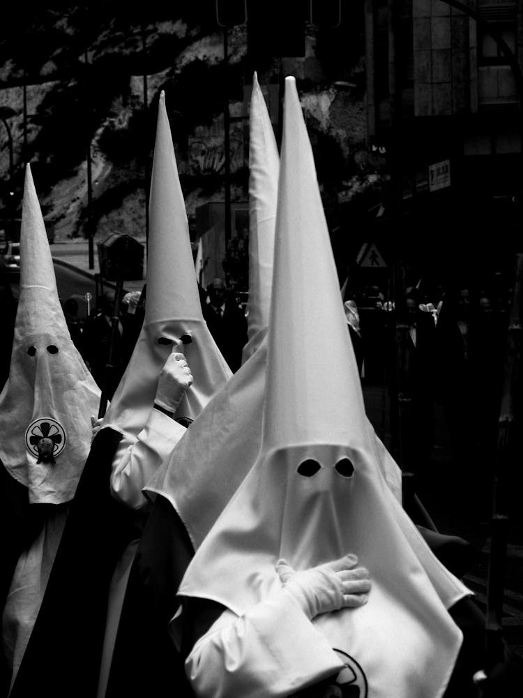 People In Hoods Walking In A Procession For The Semana Santa In Spain