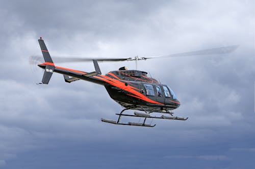 Free Red and Black Helicopter Flying in the Sky Stock Photo