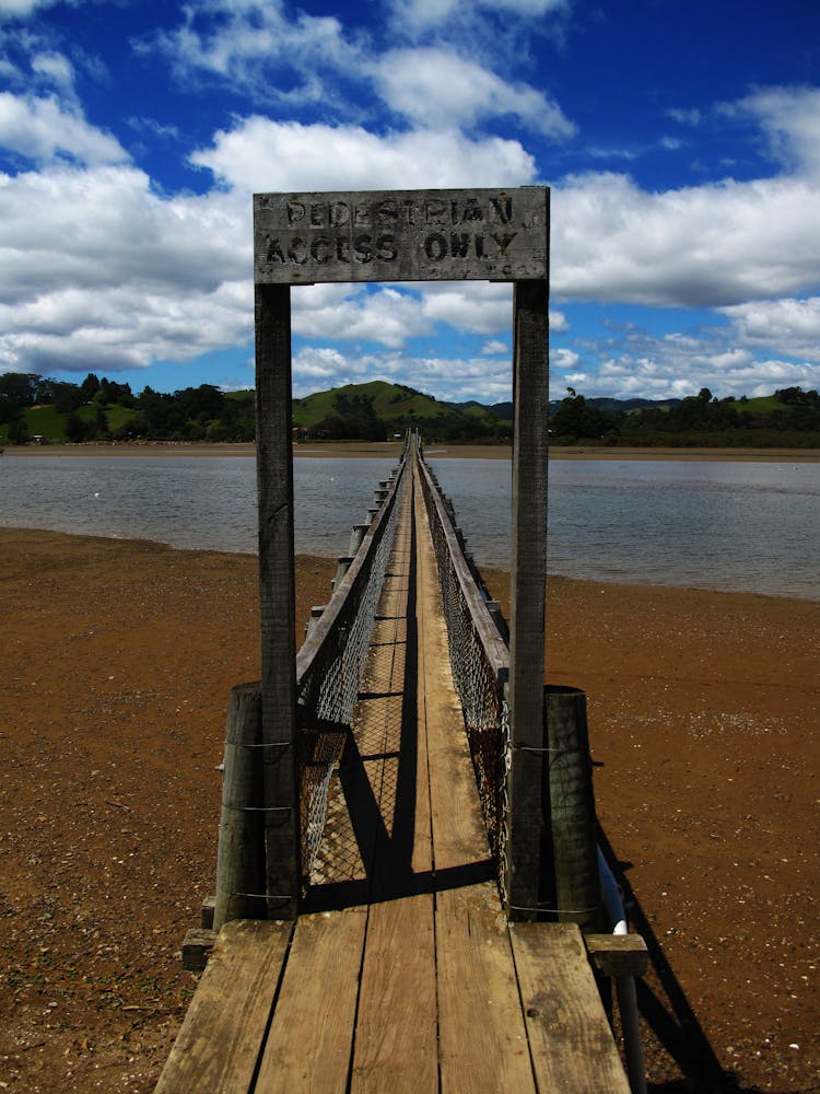 Brown Wooden Beach Dock On Beach