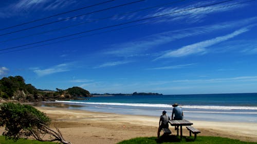 People Looking at View on Beach