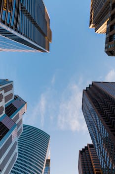 Low angle view of Chicago skyscrapers reaching towards a clear blue sky.