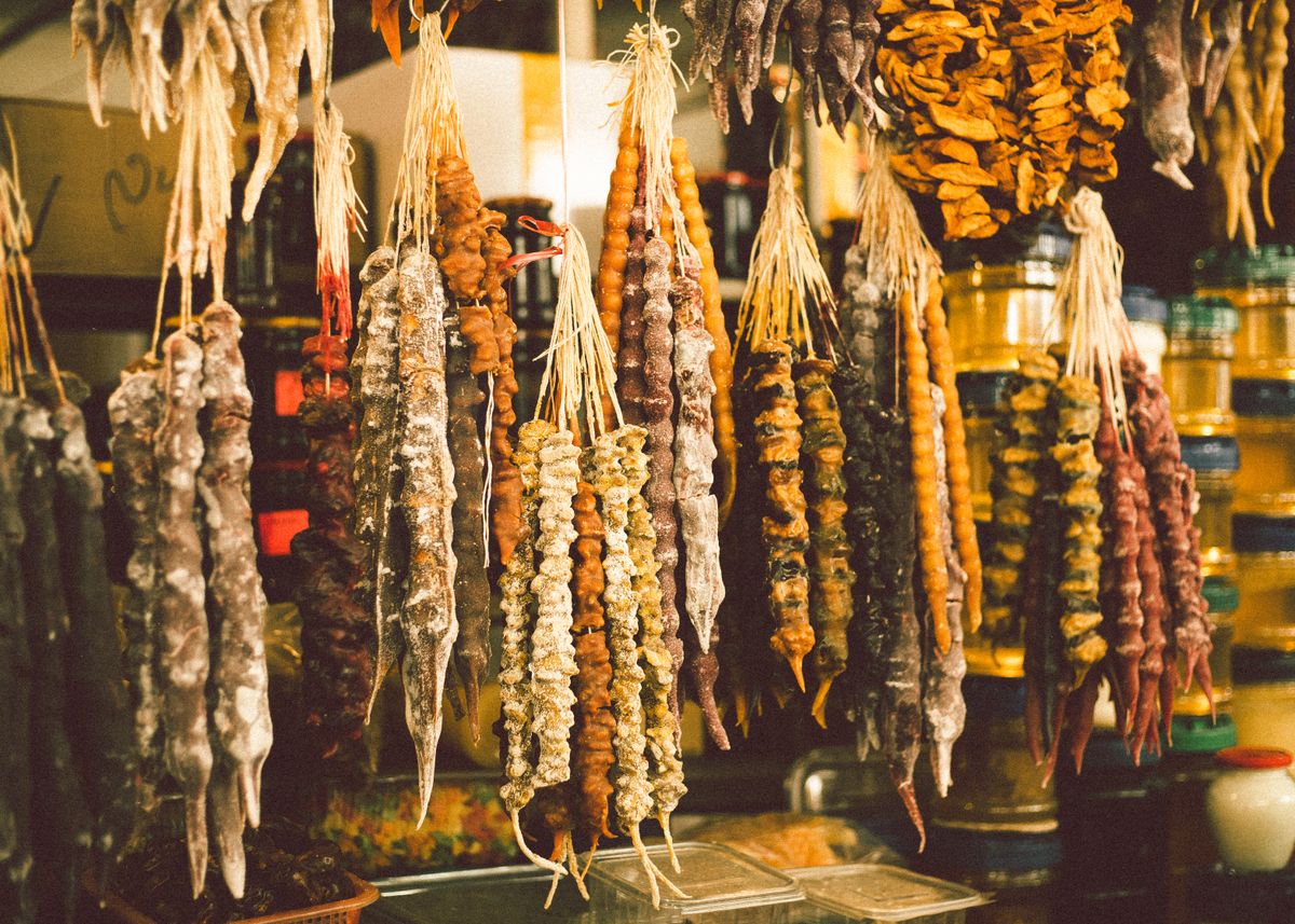 Close-up of colorful traditional Georgian churchkhela sweets hanging in a market.