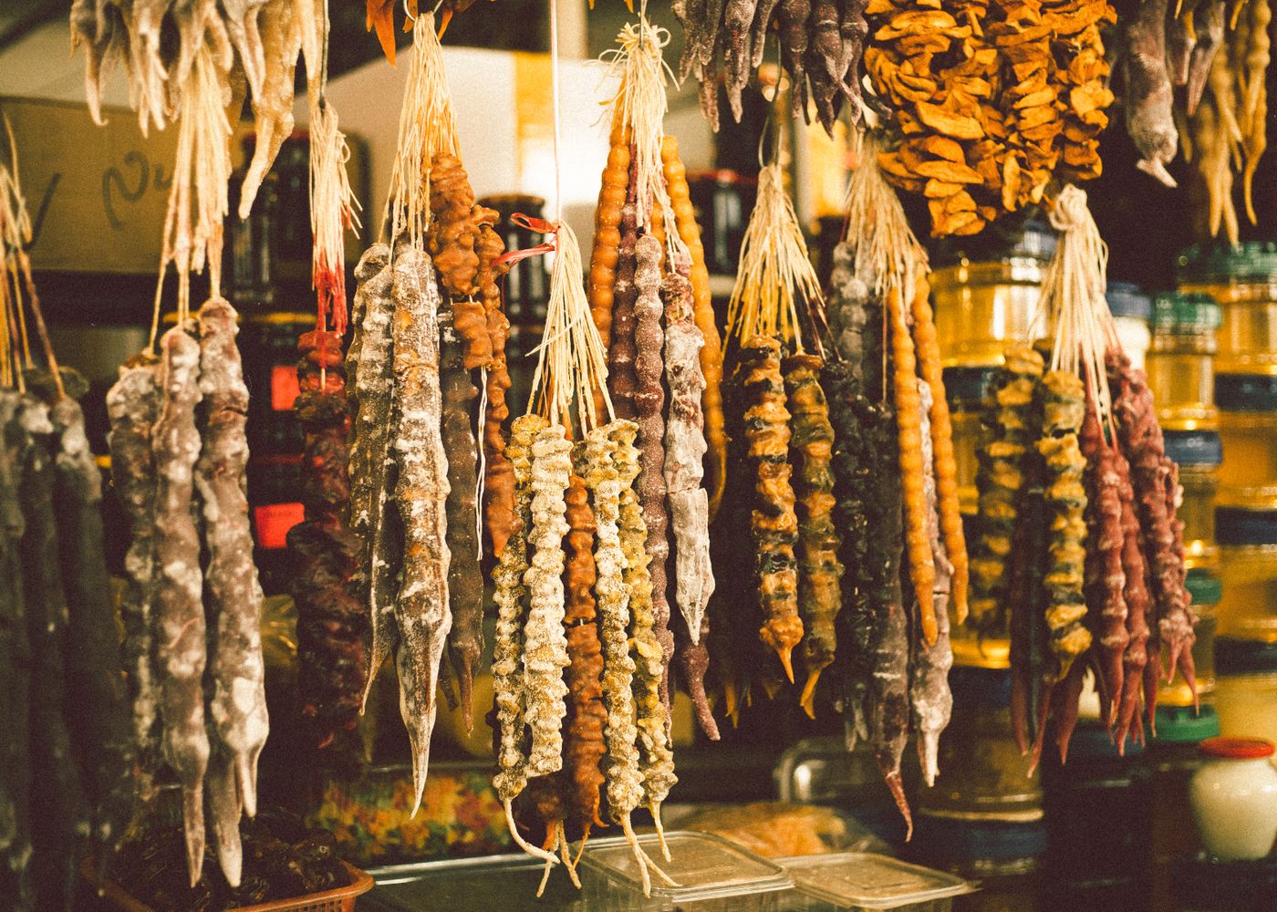 Close-up of colorful traditional Georgian churchkhela sweets hanging in a market.