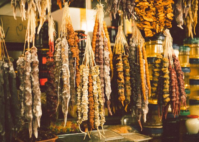 Close-up of colorful traditional Georgian churchkhela sweets hanging in a market.