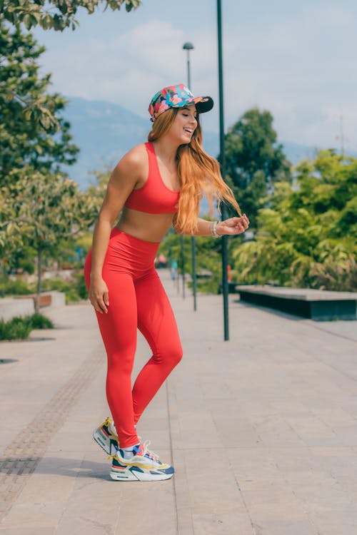 Free Woman Wearing Neon Red Activewear Stock Photo