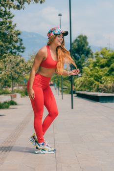 Sporty woman in Medellín enjoying an outdoor workout in vibrant activewear.